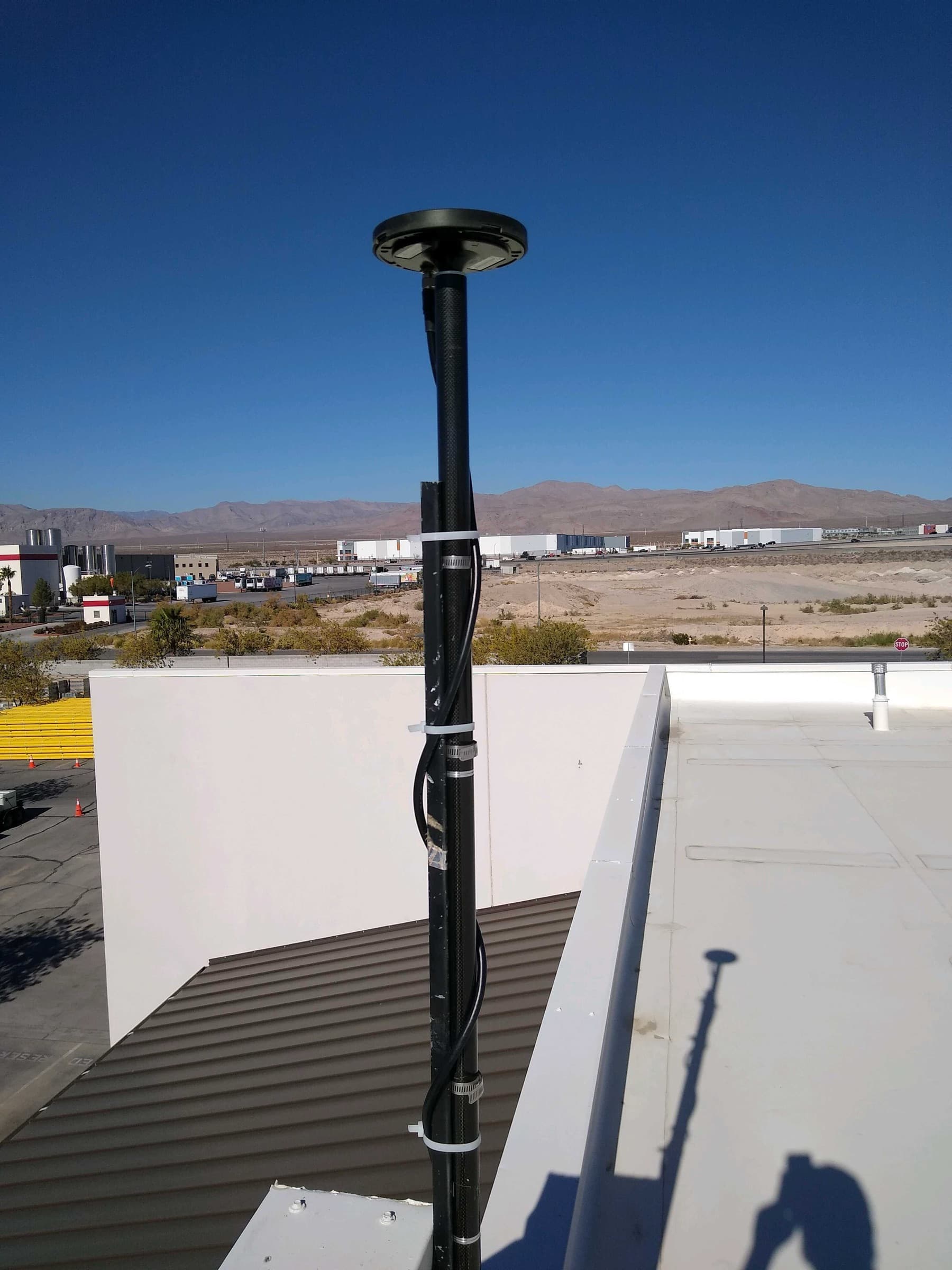 CORS reference station antenna overlooking the desert valley
