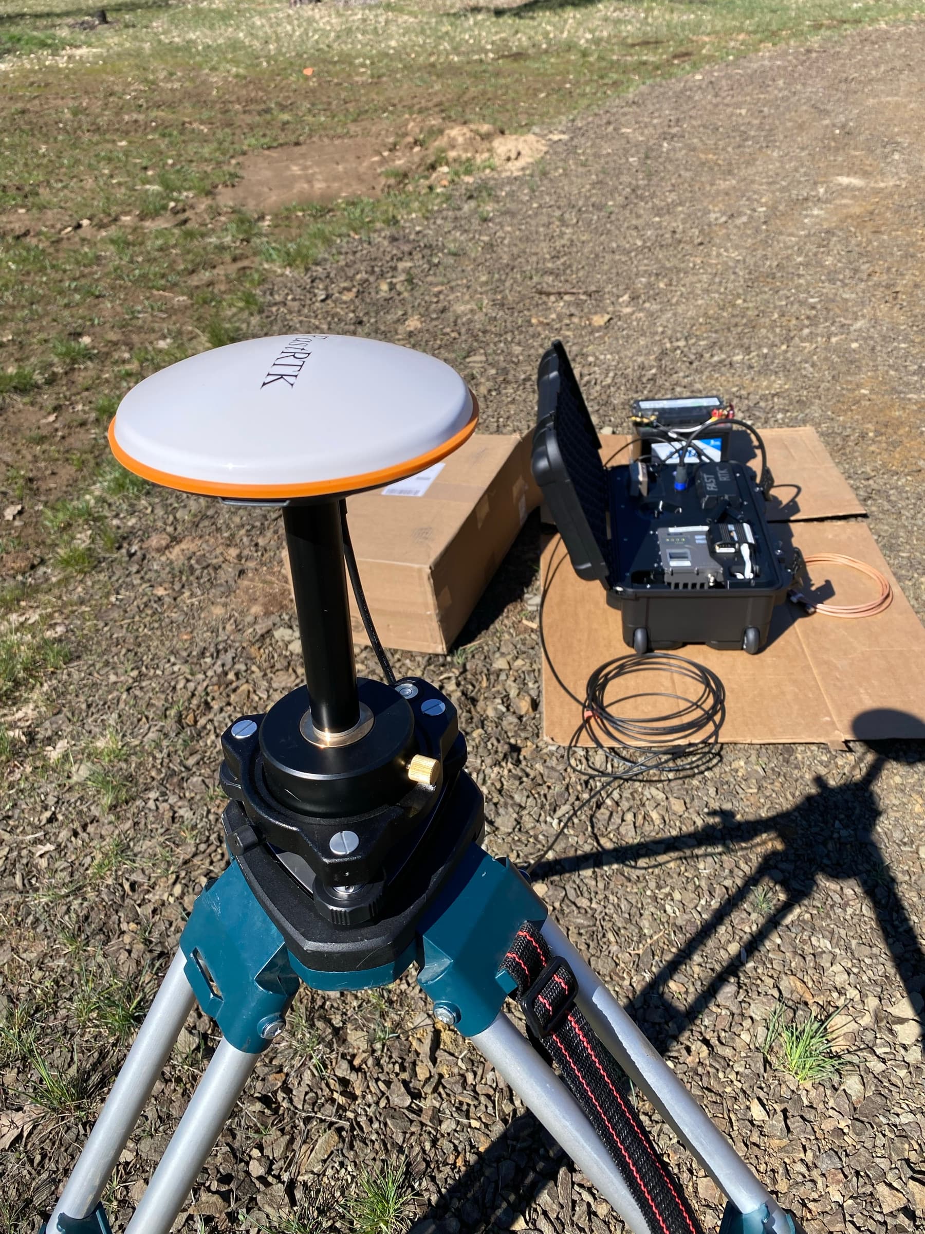 FastRTK mobile base antenna on tripod — field case deployed behind