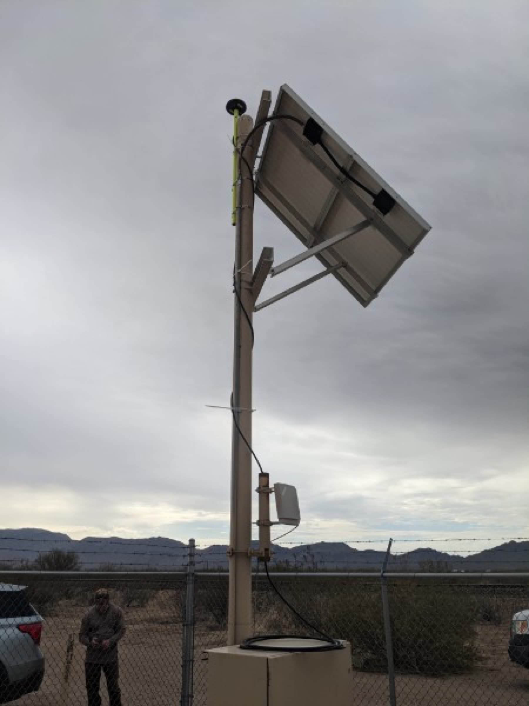Off-grid solar-powered FastRTK station in remote desert terrain